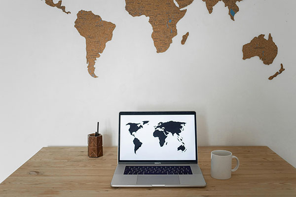 Laptop showing a world map, representing our services across five countries